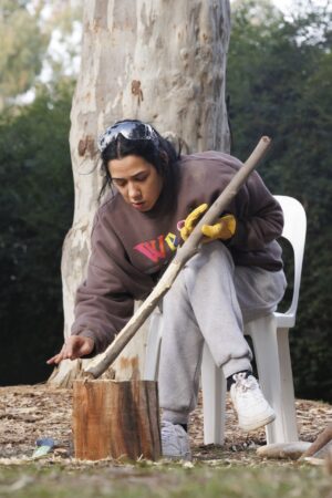 Shaping timber at a KINnected Camp, 2024