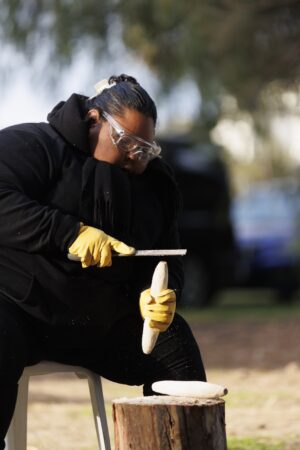 Shaping timber at a KINnected Camp, 2024