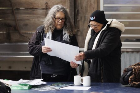 Elders examining family history records at a KINnected Camp, 2024