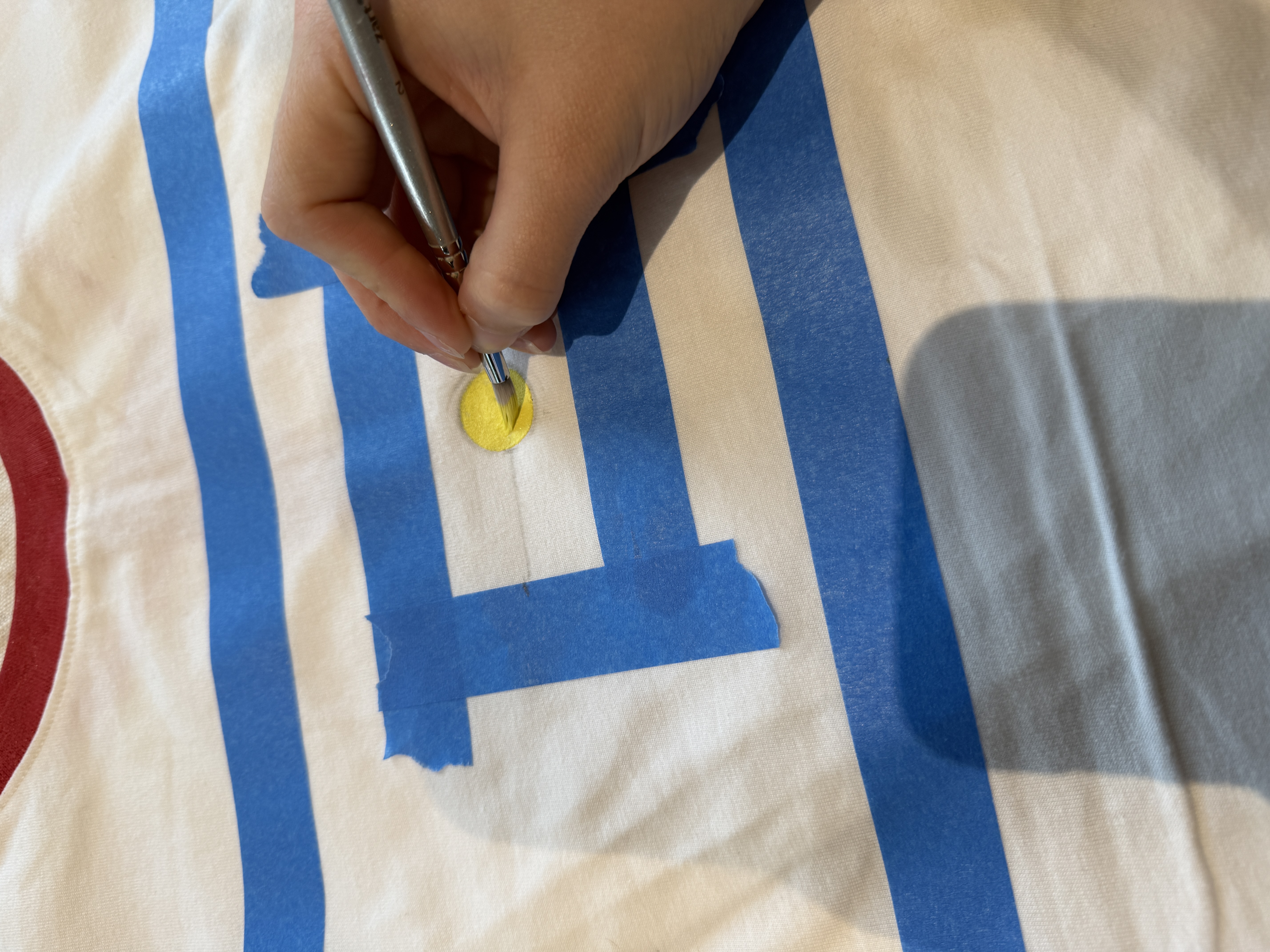 A participant painting a design on a personalised T-shirt