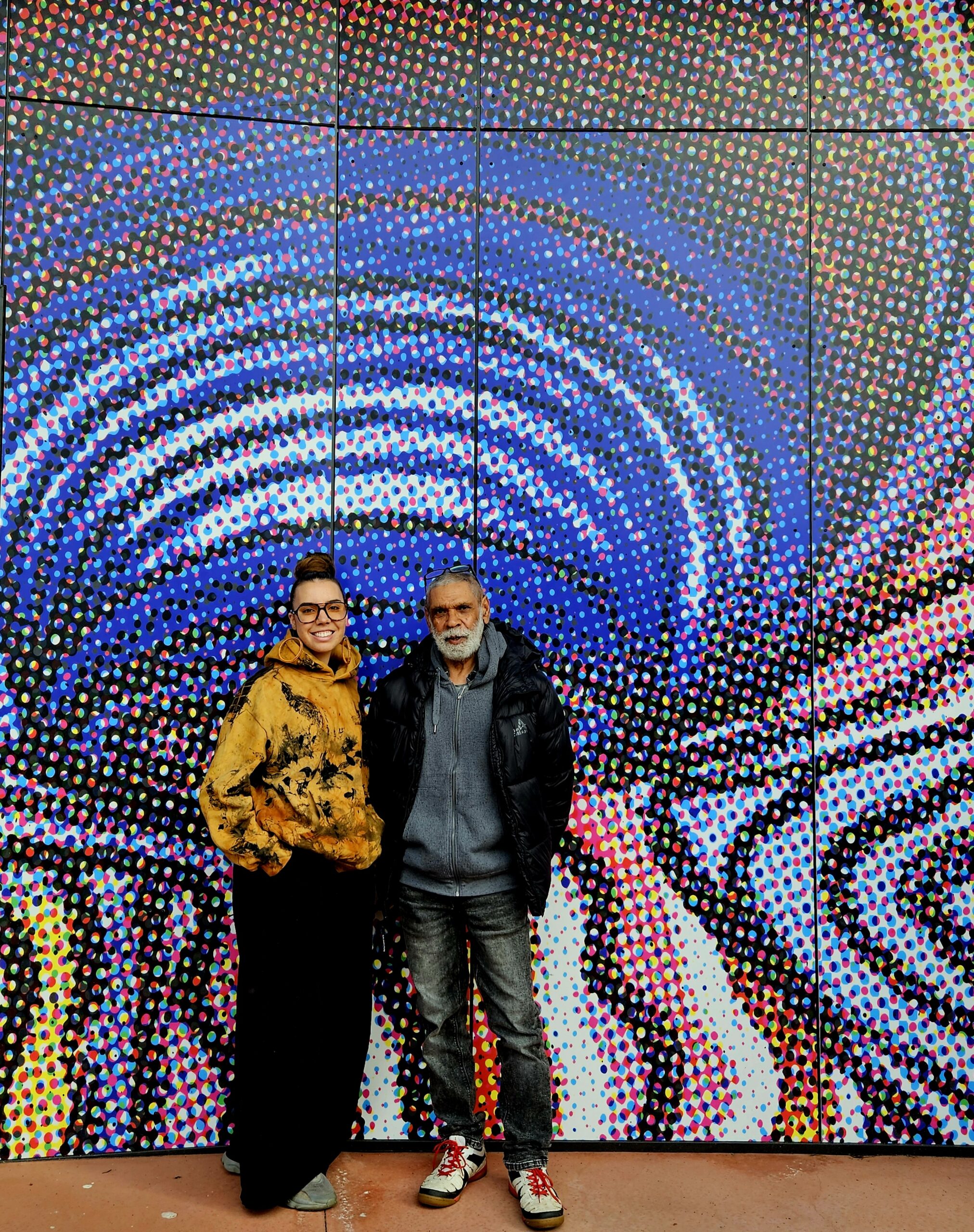 Norm Yakaduna Stewart and Kaiela Arts curator Chloe Jones in front of Stewart’s artwork at Munarra